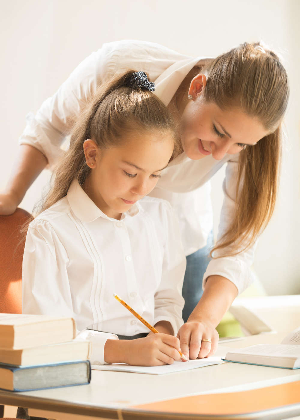 mother helping daughter with preparing to exam mother helping daughter with preparing to exam